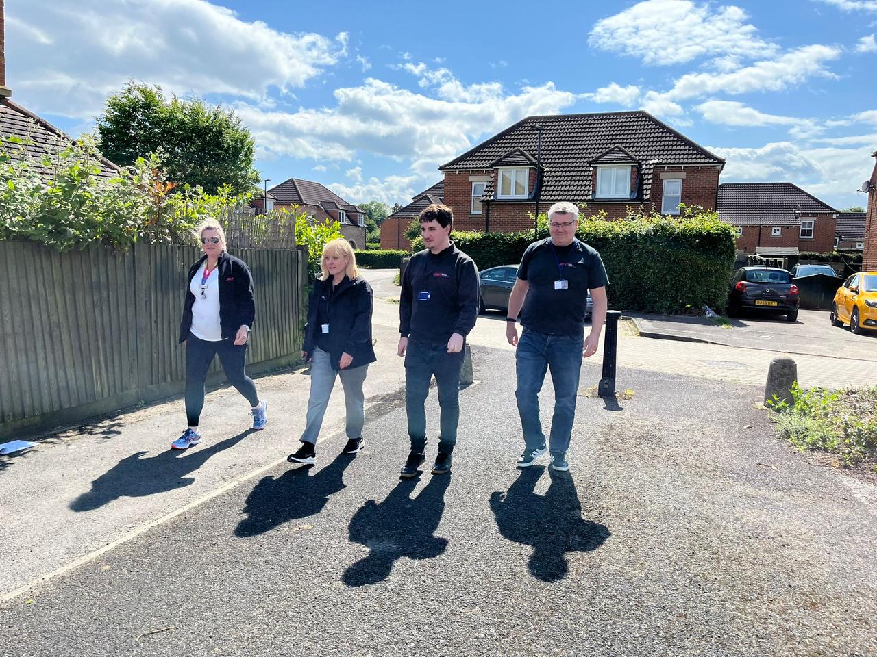 four people walking outside