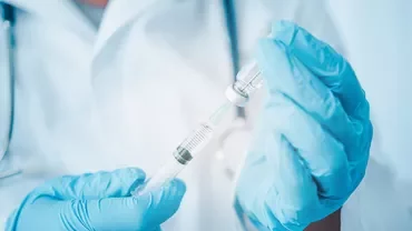 Healthcare professional preparing a syringe.