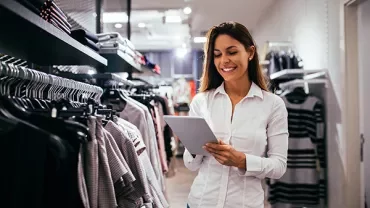 Person in clothing store using a tablet