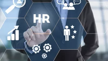 Business person pointing at HR icons on virtual interface.