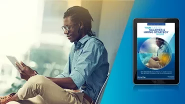 Person sitting with a tablet and a digital magazine cover on a tablet screen.