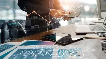 Person analyzing digital graphs on a tablet in an office