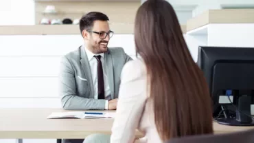 Two people in an office having a conversation.