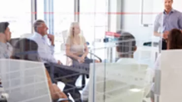 Group of people having a meeting in a modern office setting.