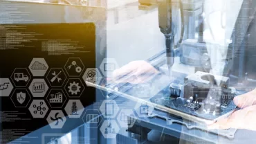 Person working with industrial technology and graphic interfaces.
