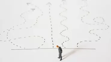 Figure stands before a choice of winding paths.