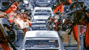 Robots assembling cars on an automated production line.